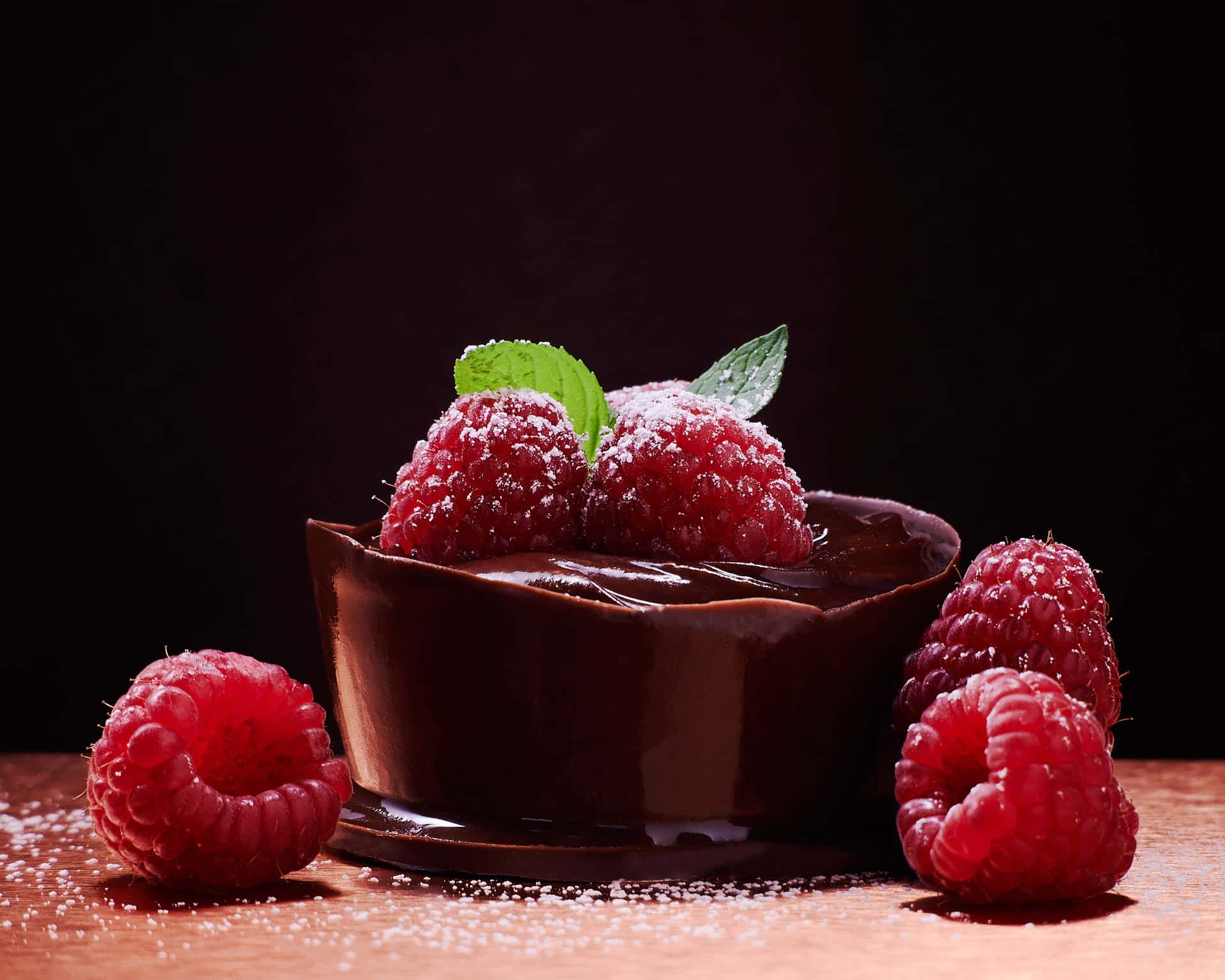 Chocolate pudding in a cup with raspberries