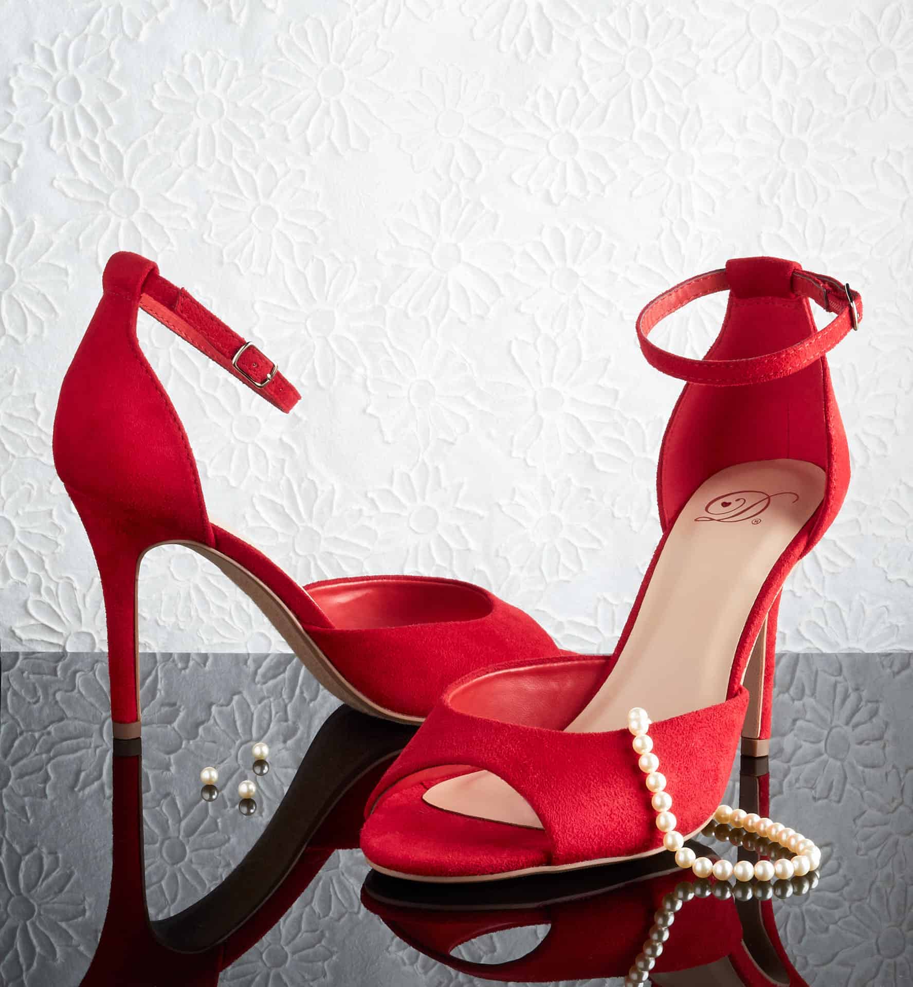 Pair of red heels with pearls