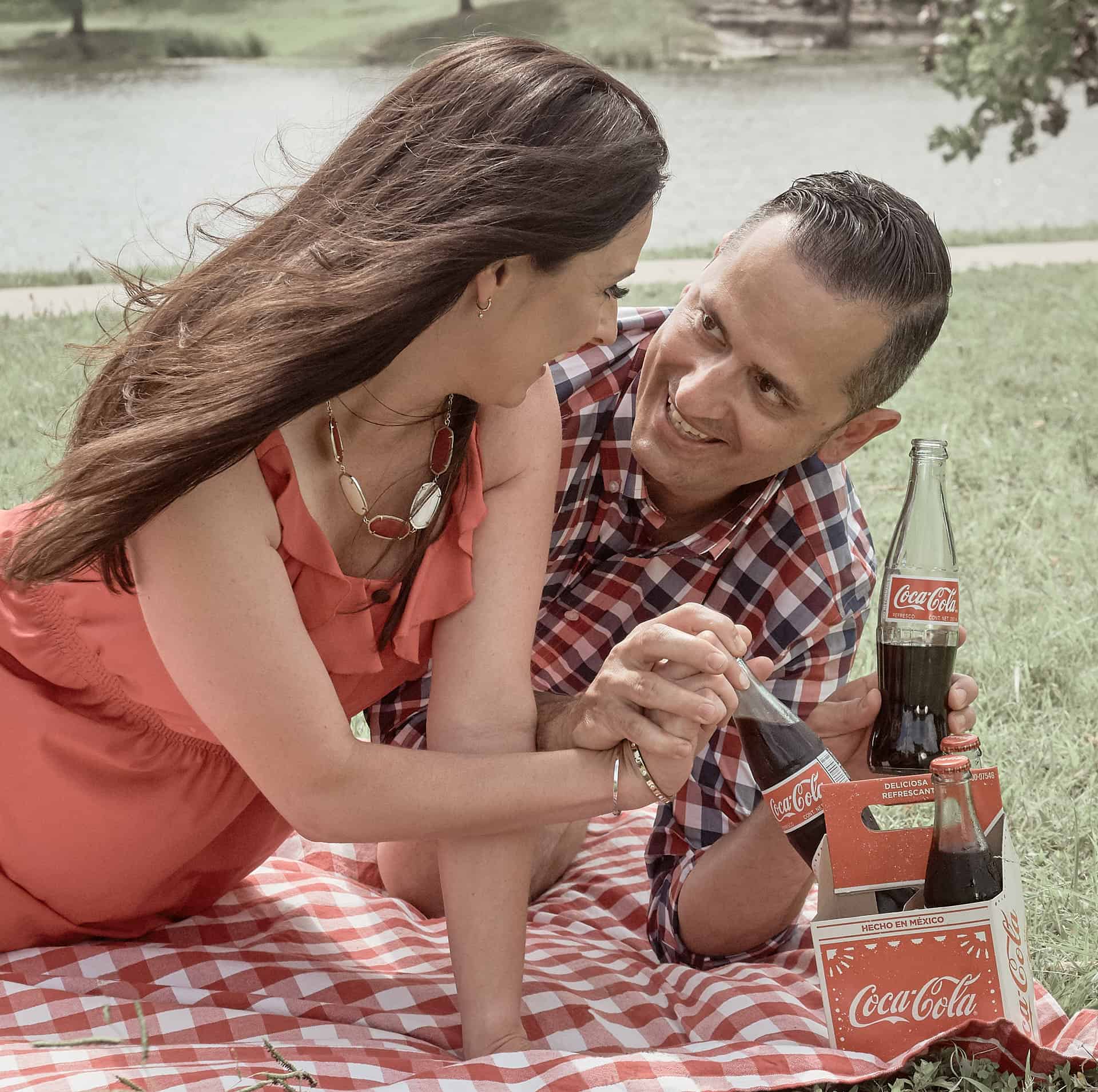 Couple in park drinking Coca-Cola.